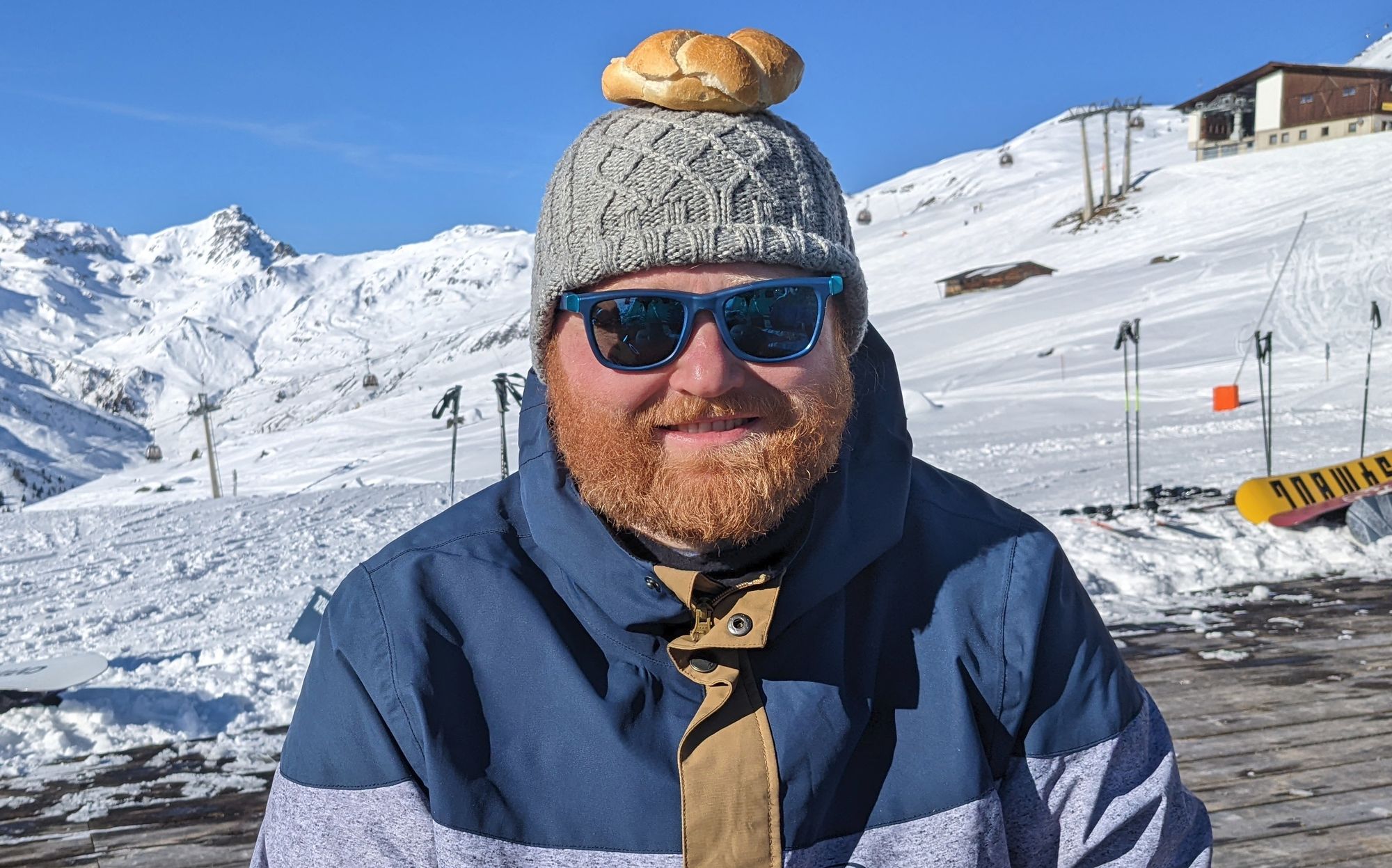 A picture of Andrej with sunglases and a bun on his head