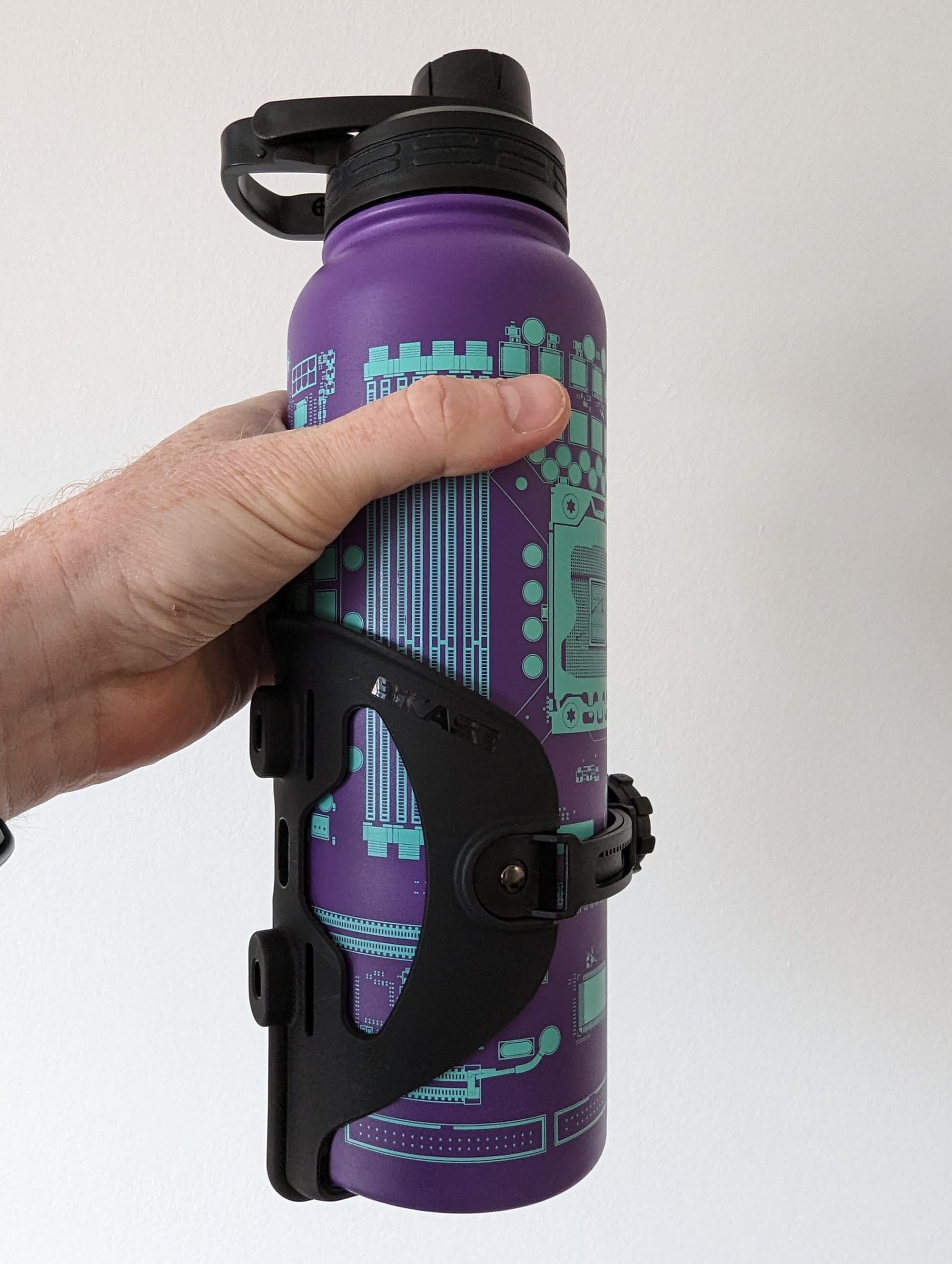 A metal water bottle in bottle cage for a bike