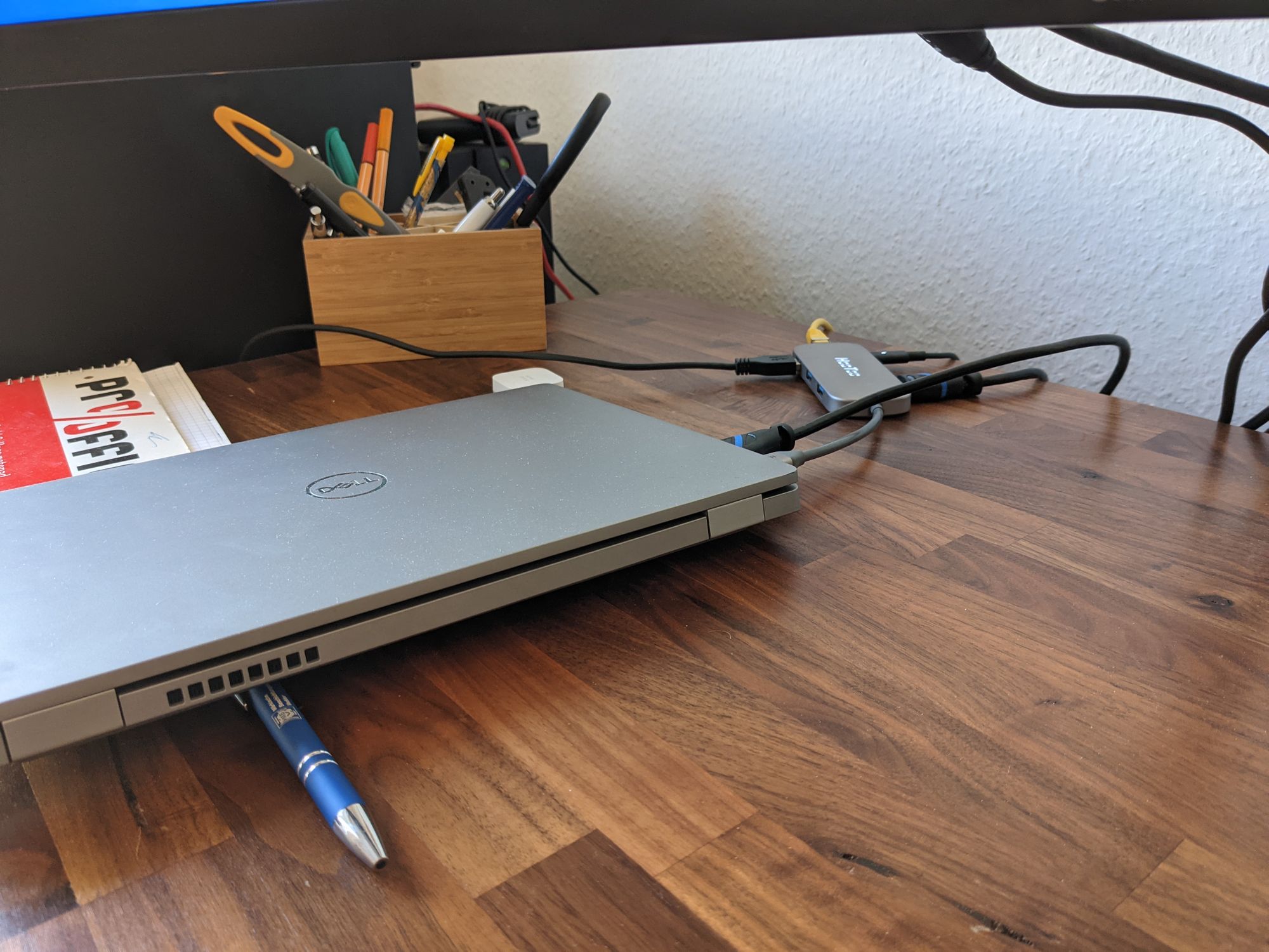 Pen holding up a laptop