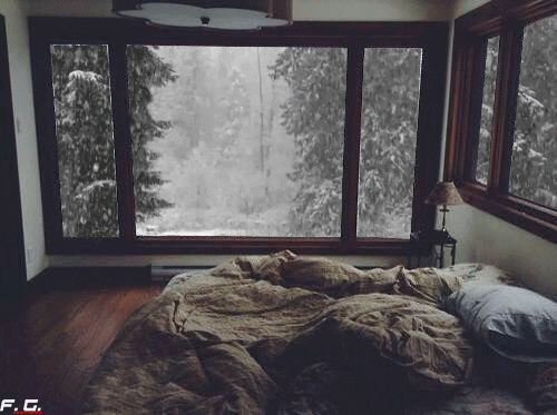 Bed with snow in the window