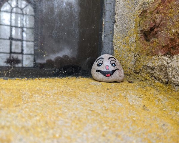 Happy face drawn on a stone